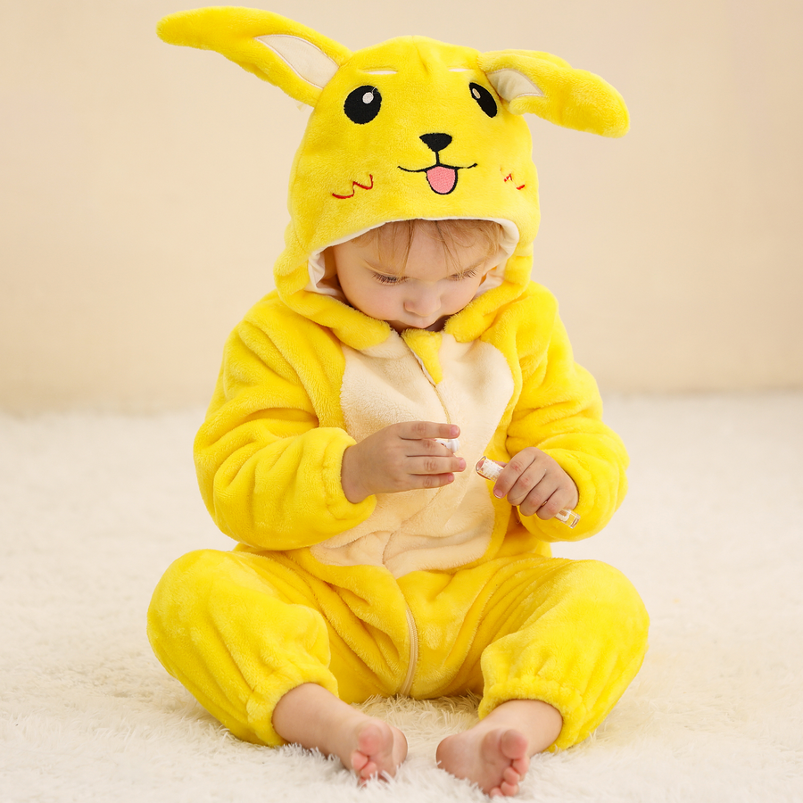 Et blødt og farvestrålende gult Pikachu-kostume til børn, formet som en heldragt med en integreret hætte, der har de ikoniske lange ører og et sødt ansigt broderet på toppen. Dragten er lavet af behageligt flannelmateriale og har en praktisk lynlås på forsiden til nem påklædning.